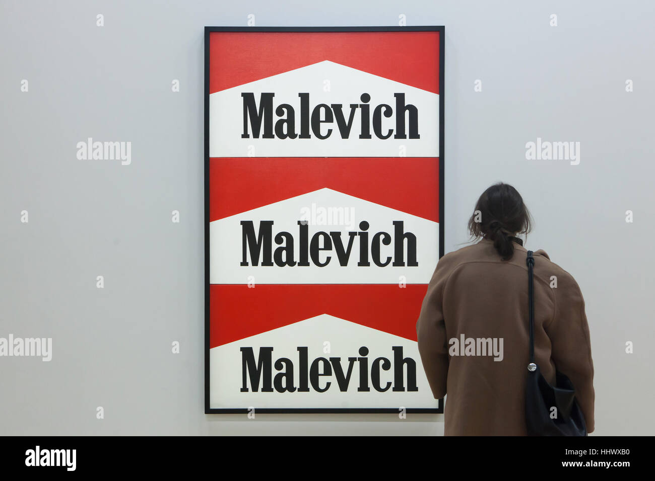 Visitante delante de el jadeo titulado Malevich-Marlboro (1985) por el artista conceptual ruso Alexander Kosolapov mostrado en la exposición dedicada al arte contemporáneo rusa y soviética de 1950 a 2000 en el Centro Pompidou en París, Francia. La exposición titulada Kollektsia! (Colección!) se extiende hasta el 27 de marzo de 2017. Foto de stock