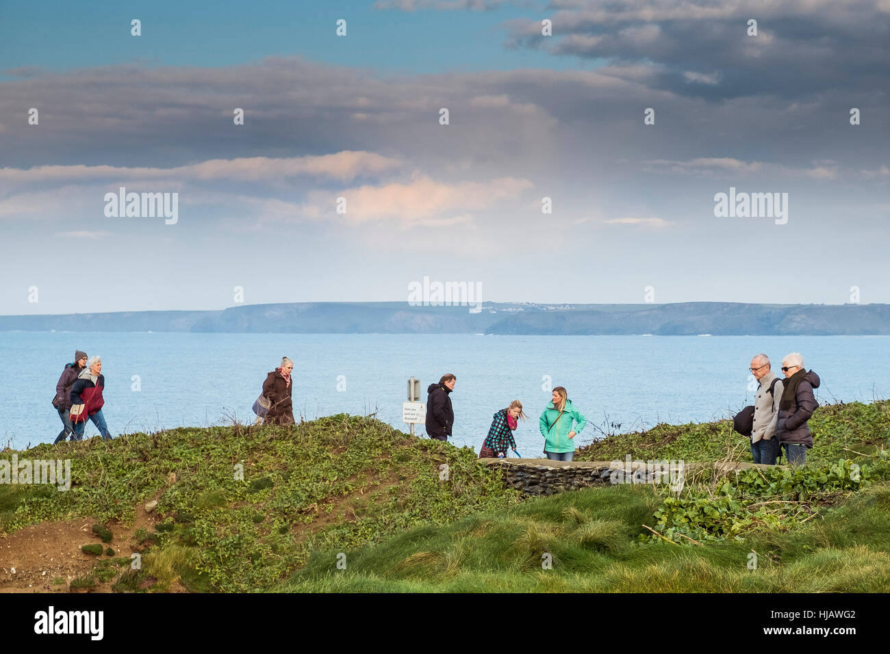 La gente caminando. Los turistas disfrutan de un paseo a lo largo de la ruta costera en Newquay, Cornwall. Foto de stock