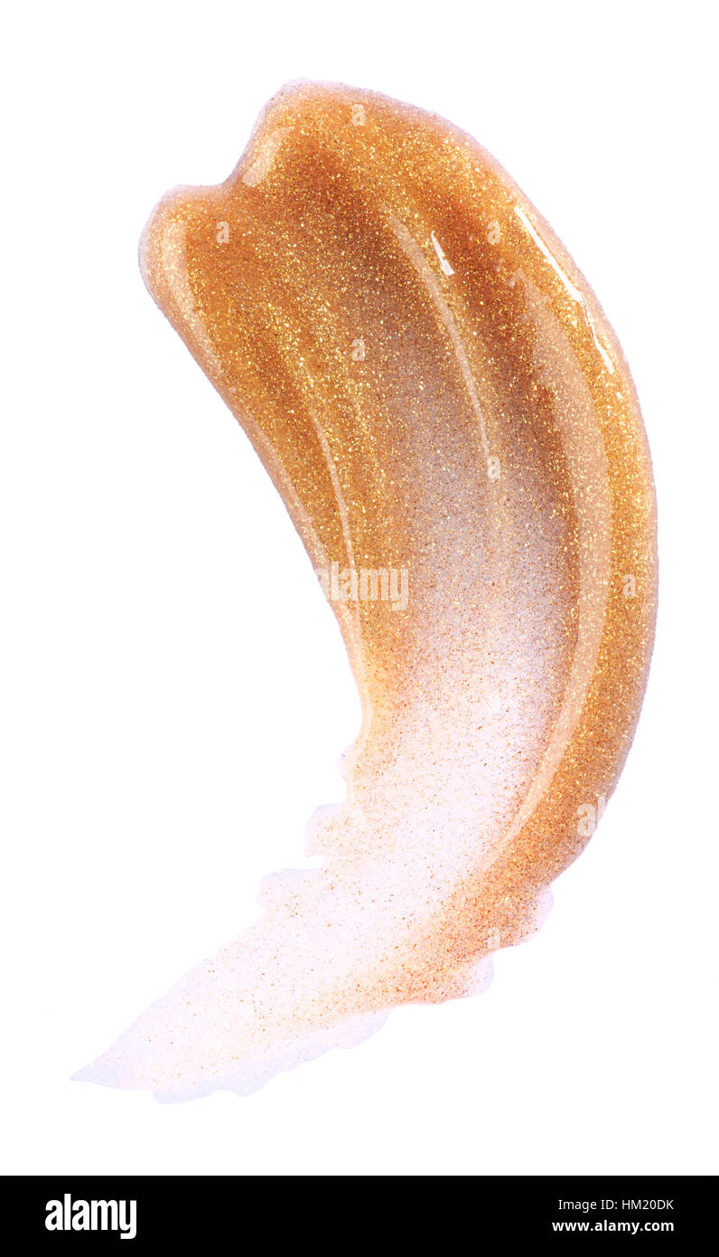 Un recorte de la belleza de la imagen de una muestra de oro lip gloss translúcido. Foto de stock