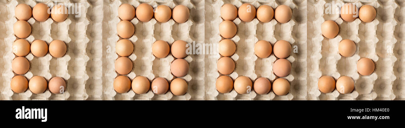 Los huevos de la palabra escrita a partir de huevos de pollo cruda sobre cartón Foto de stock
