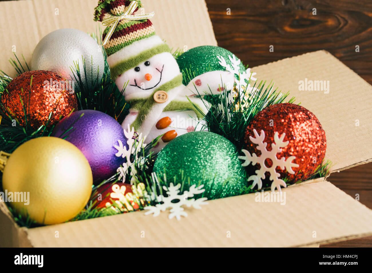 Adornos navideños y juguetes en una caja de cartón sobre un fondo de madera  closeup Fotografía de stock - Alamy