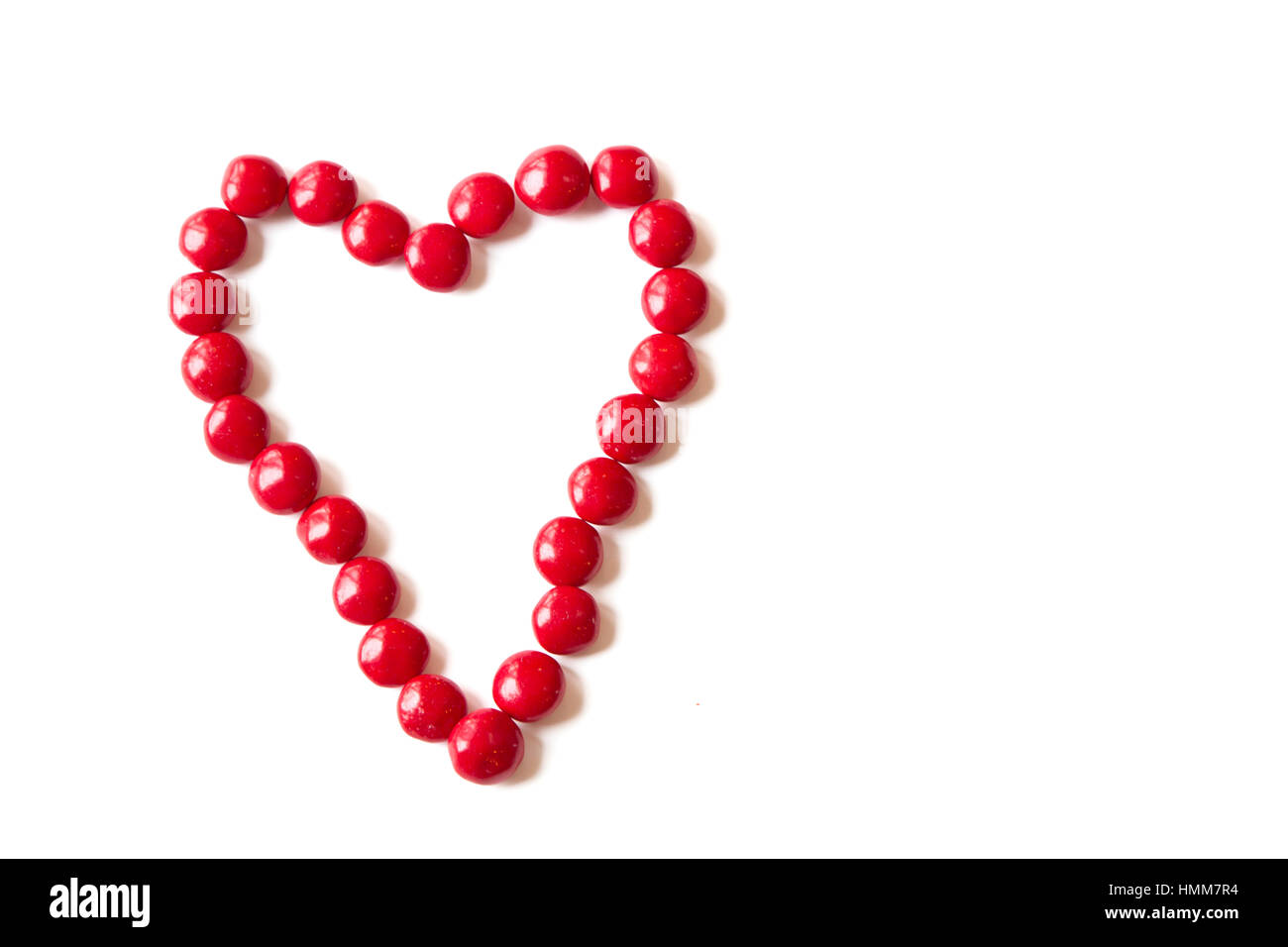 Colorido Caramelo Rojo en forma de un corazón aislado sobre fondo blanco. Foto de stock