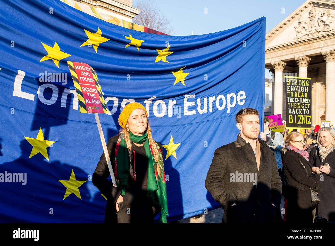 Londres, Reino Unido - 21 de enero de 2017. Los manifestantes anti brexit holding y anti Trump firmar pararse delante de la bandera de la UE.Miles de manifestantes se reunieron en Traf Foto de stock