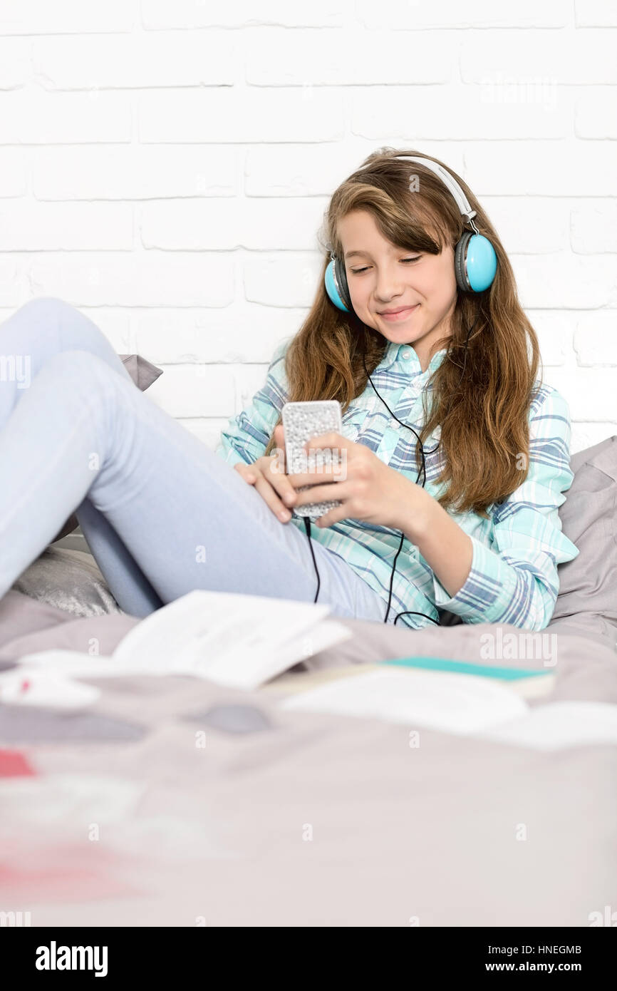 Chica escuchando música en casa Foto de stock