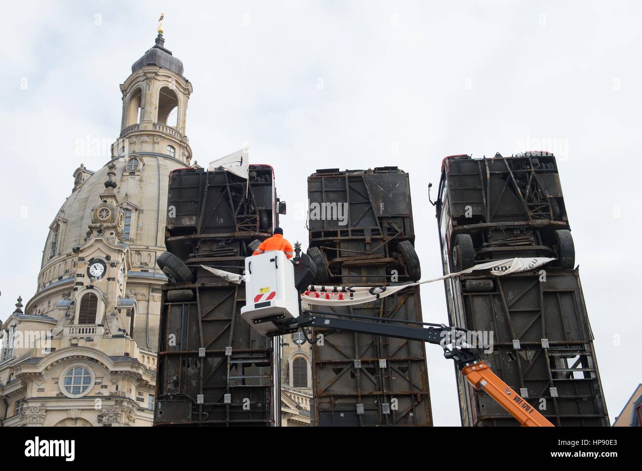 Dresden, Alemania. 20 Feb, 2017. Los empleados de los servicios técnicos Centrales en Dresde retirar una bandera y una bandera del grupo de extrema derecha "Identitaere Bewegung" de la escultura "monumento" del artista German-Syrian Manaf Halbouni en el Neumarkt en Dresden, Alemania, el 20 de febrero de 2017. Los miembros del grupo, que está siendo vigilada por la Oficina para la protección de la Constitución, colocó la bandera y la bandera en el mismo día, hacer que la acción pública vía internet. Foto: Sebastian Kahnert/dpa-Zentralbild/dpa/Alamy Live News Foto de stock