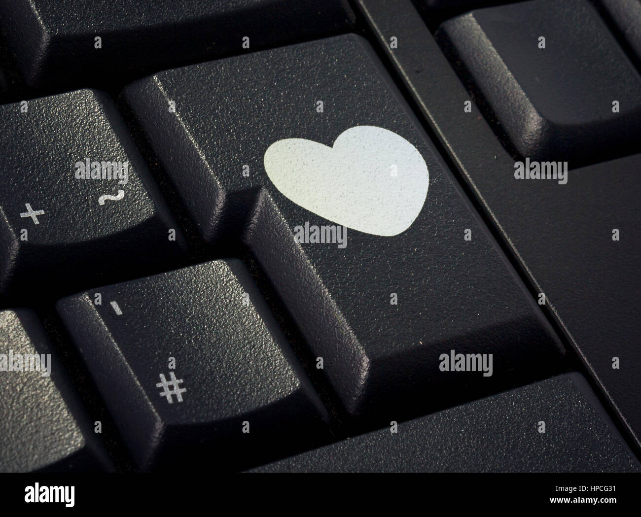 exprimir guitarra Contestar el teléfono La tecla de retorno de un teclado negro con la forma de un corazón impreso  .(serie Fotografía de stock - Alamy