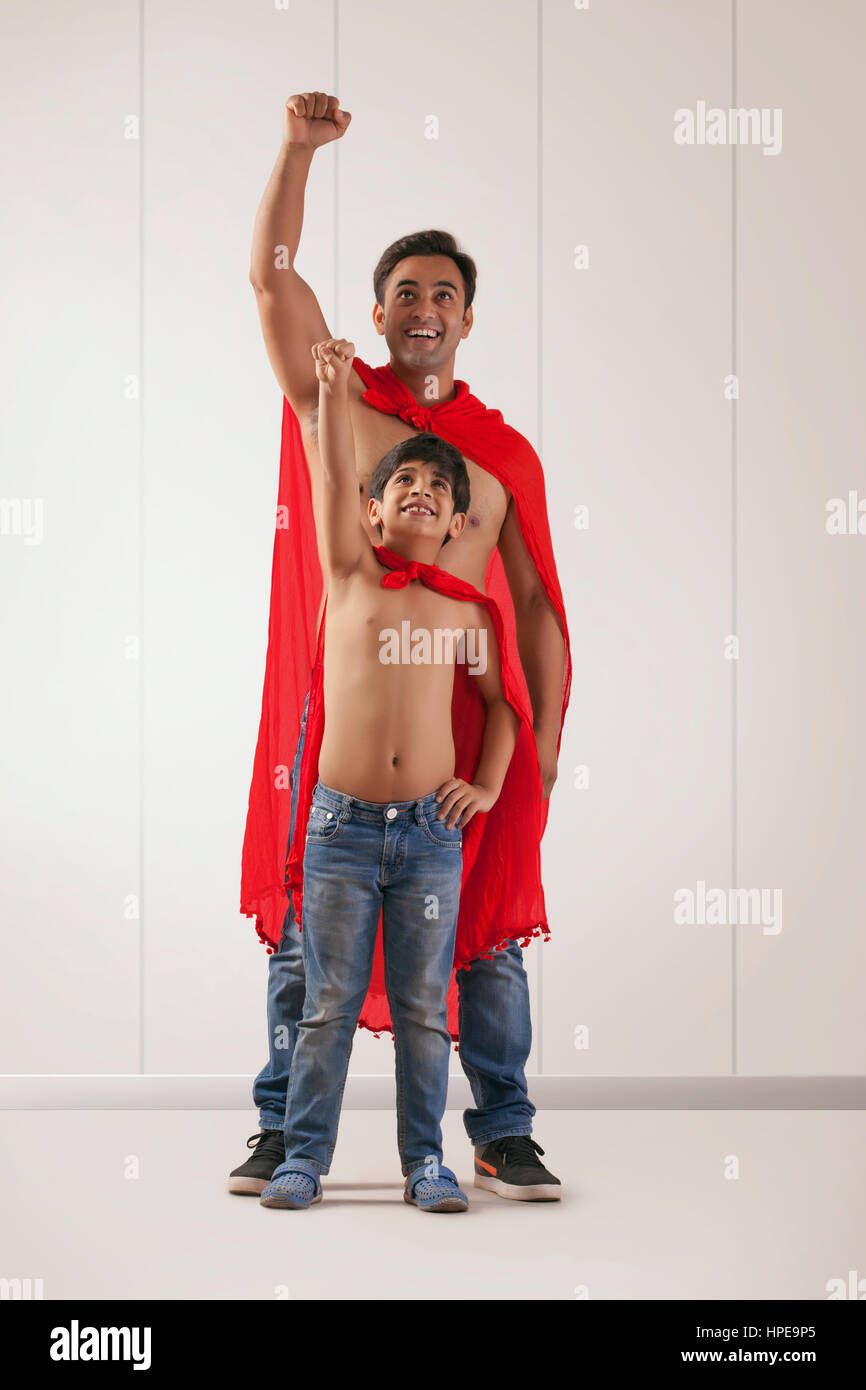 Padre e hijo actuando como super héroes Foto de stock