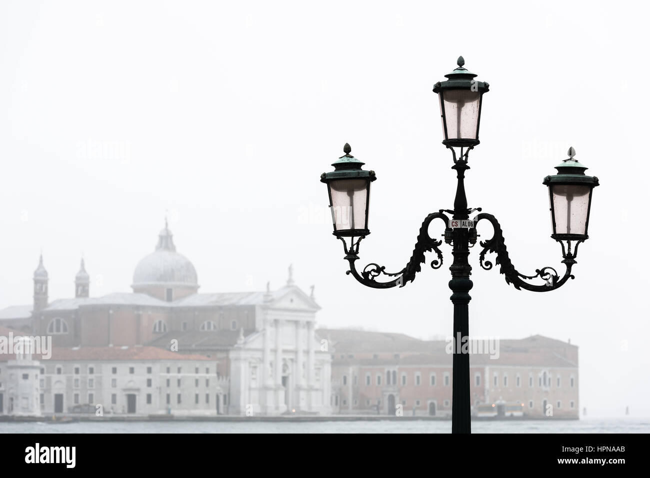 La Chiesa di San Giorgio Maggiore visto detrás de un farol de la calle tradicional de Venecia Foto de stock