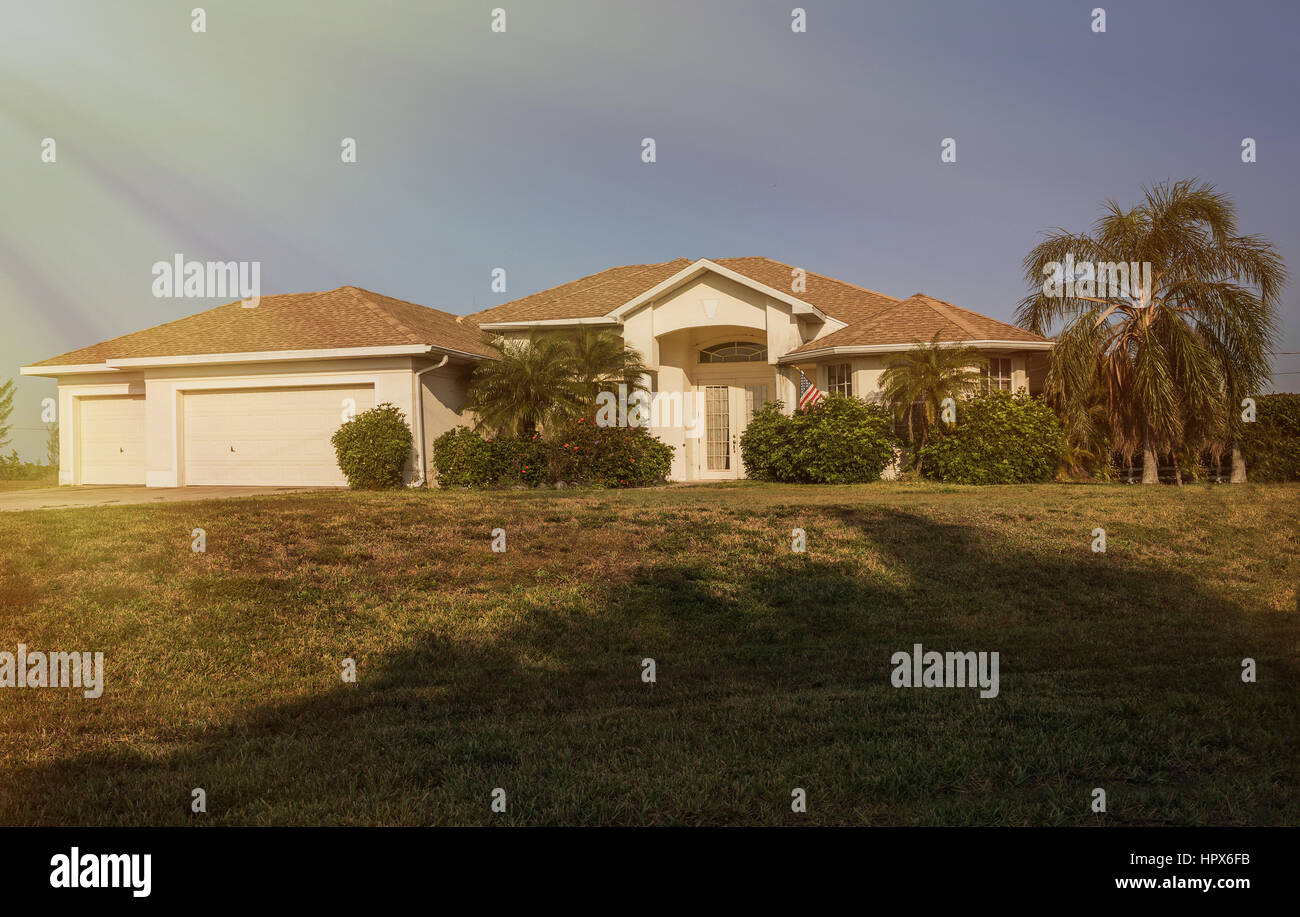 El sur de la florida casa unifamiliar en día soleado suroeste de Florida típico de bloque de hormigón de estuco y casa en el campo, con palmeras, bosques tropicales Foto de stock