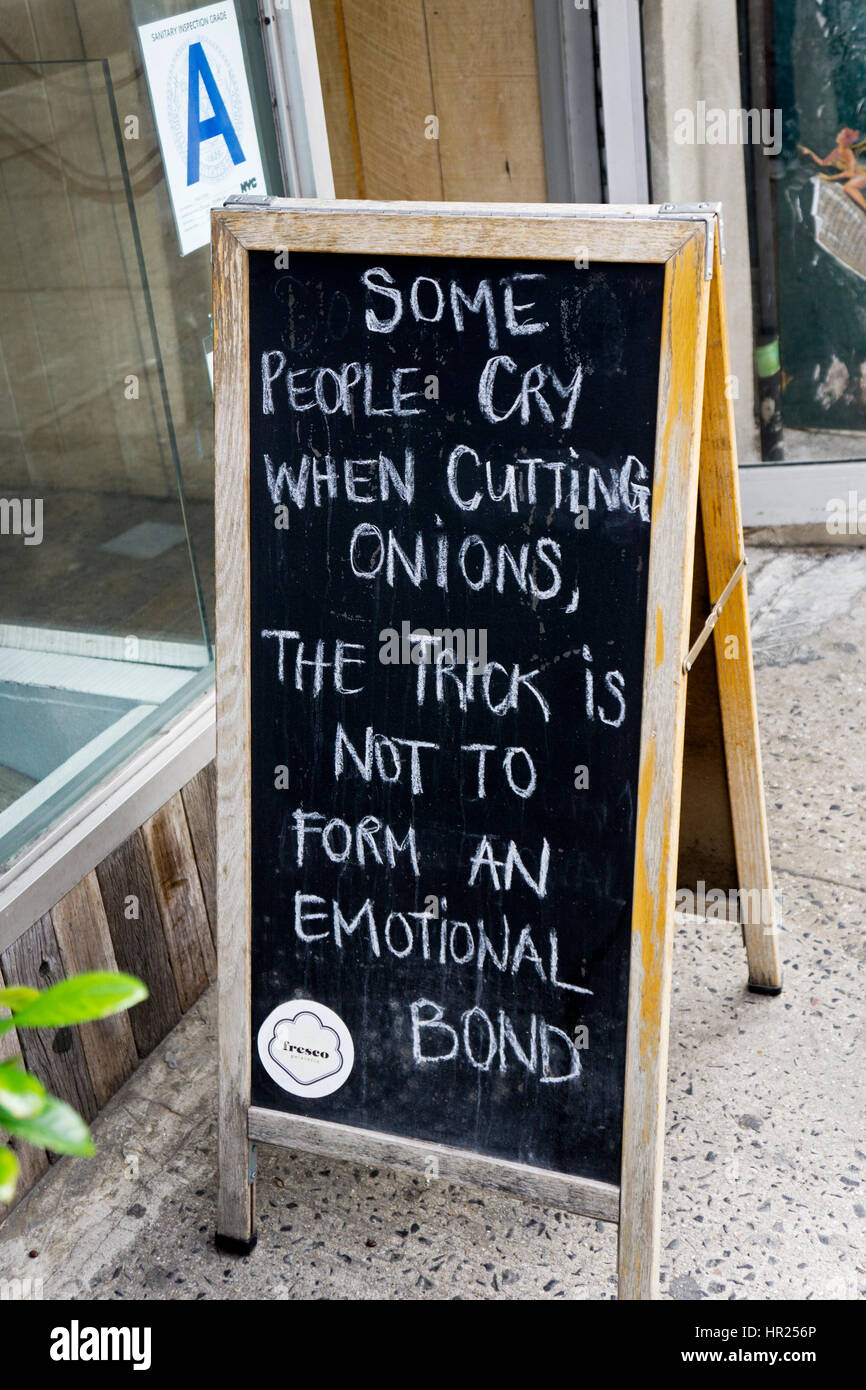Un gracioso firmar unos llorando mientras trocear las cebollas. Fuera Fresco Gelateria en la Segunda Avenida en Manhattan Foto de stock