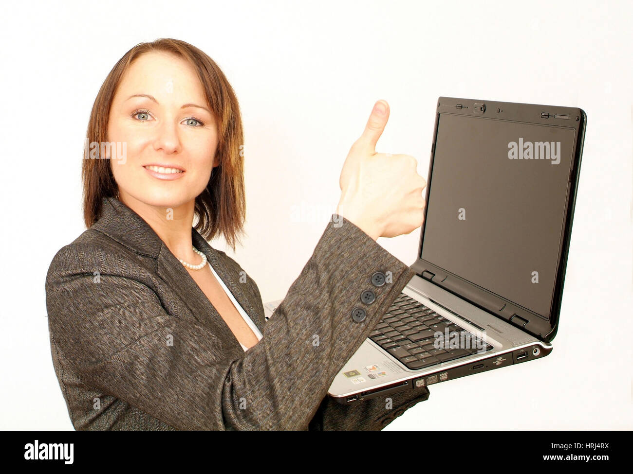 Junge, Gesch optimistische?ftsfrau mit Laptop - joven y exitosa mujer de negocios con ordenador portátil, Symbolfotos Foto de stock