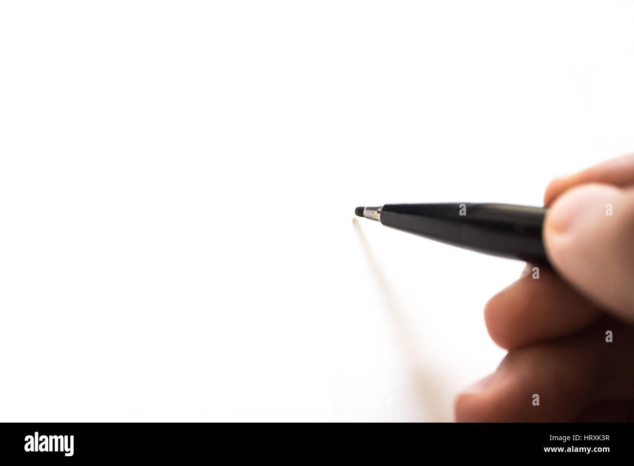 Marca de lápiz escribiendo sobre papel blanco. Enfoque borroso. Foto de stock