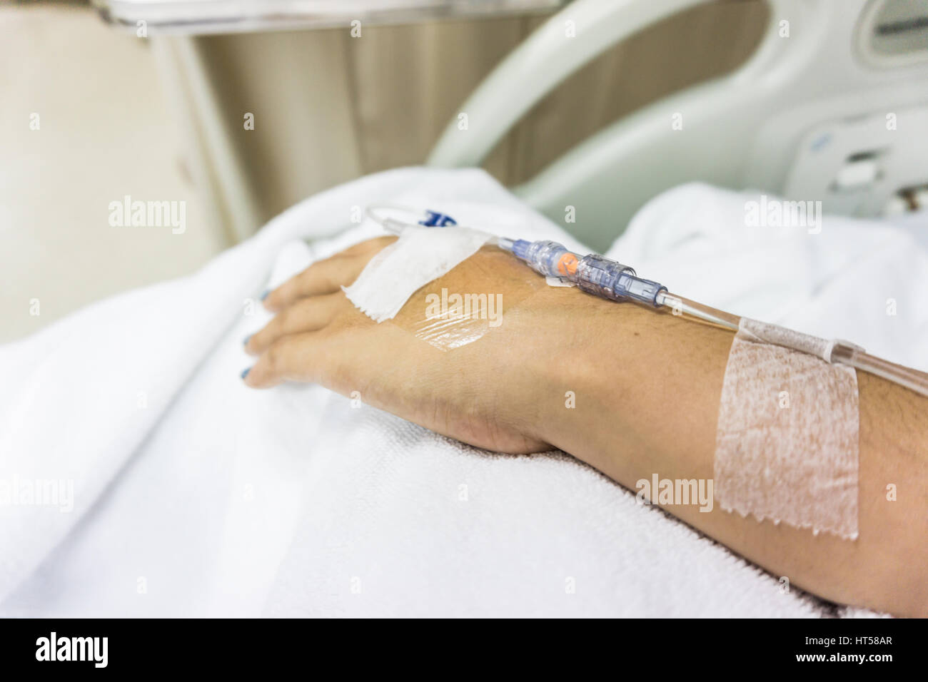 Primer plano de manos con sonda intravenosa a mano del paciente en la cama  del hospital Fotografía de stock - Alamy
