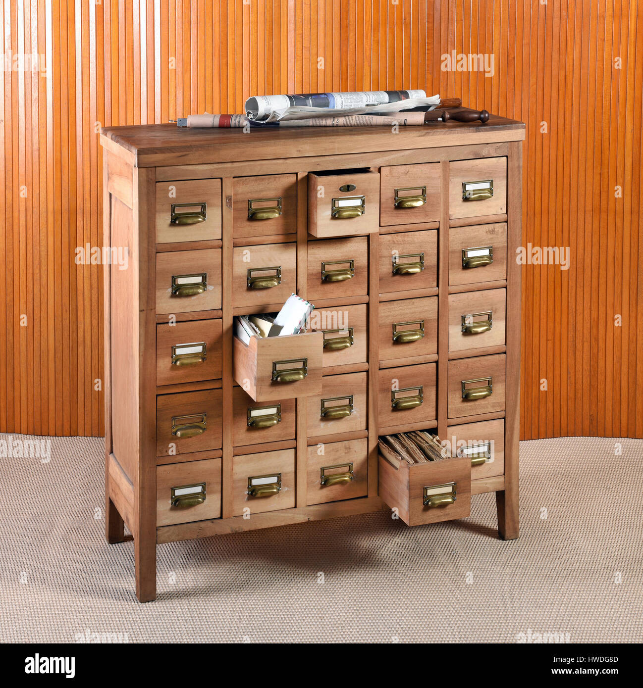 Armario archivador de madera para almacenamiento con filas de pequeños  cajones con asas de latón y etiquetas, dos cajones se abren mostrando  contenido Fotografía de stock - Alamy