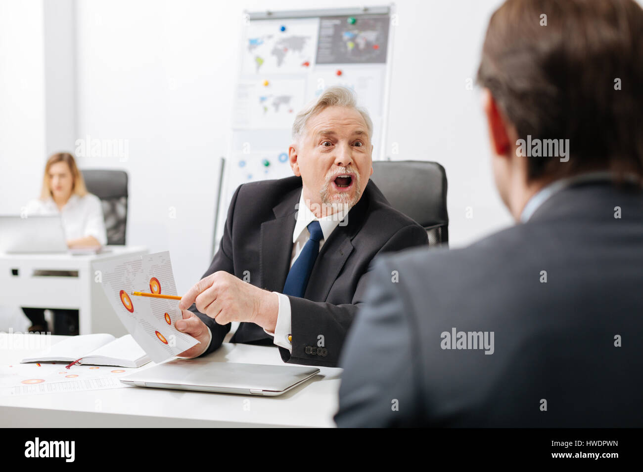 Enojado empleador expresando feroz en la oficina Foto de stock