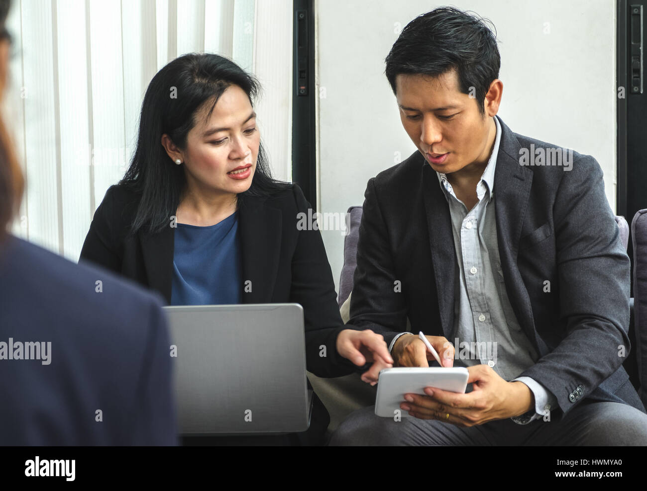 Mujer y hombre de negocios con tablet,portátil para aplanar el trabajo en reuniones corporativas en Office,conferencias empresariales concepto. Foto de stock