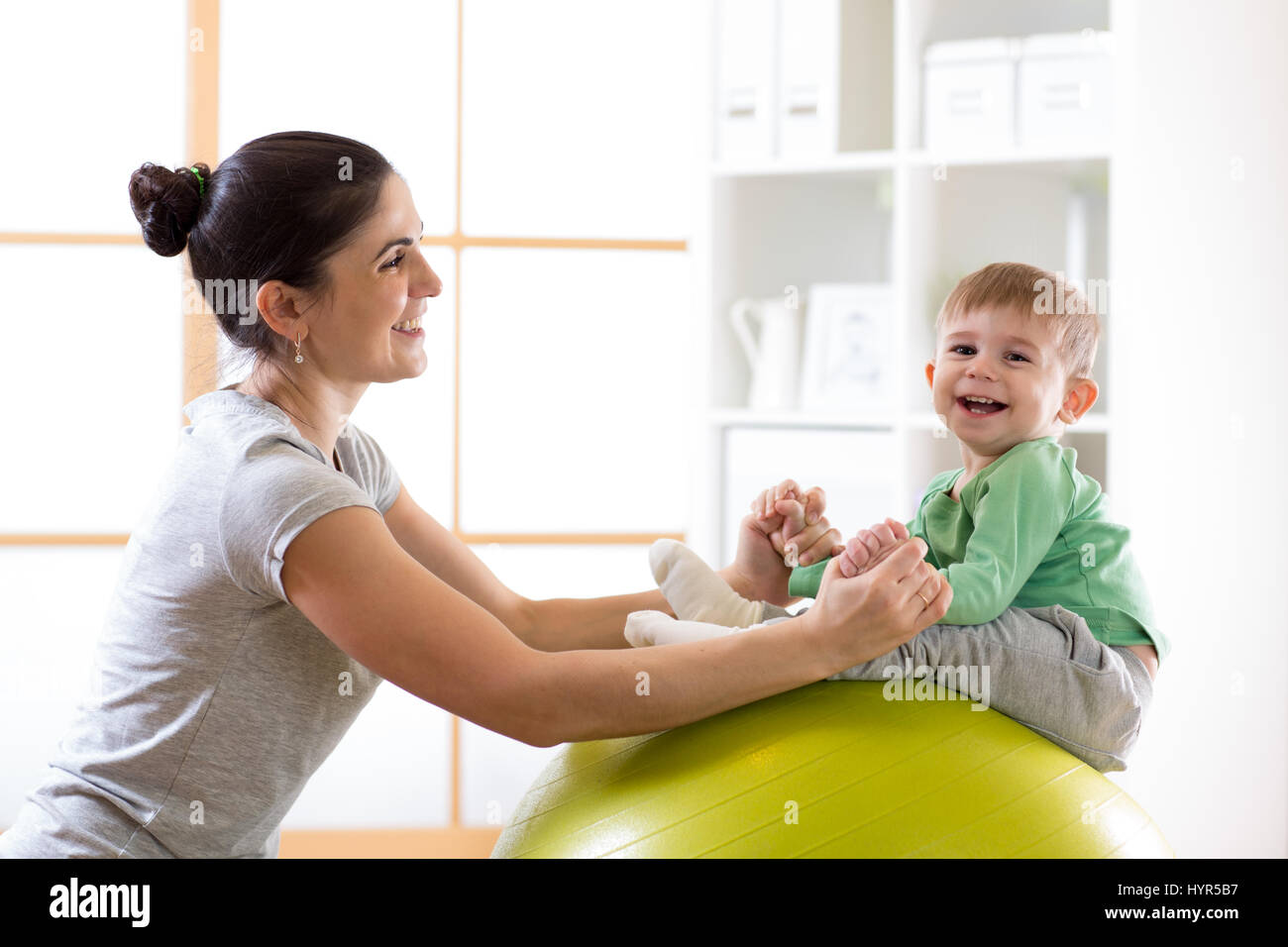 La Madre Y El Bebe Feliz Haciendo Yoga En Colocar La Bola Fotografia De Stock Alamy