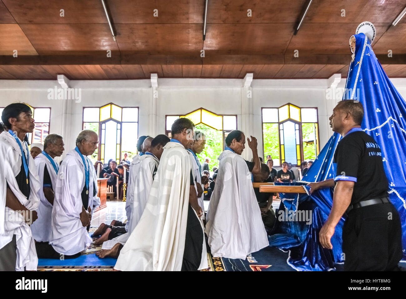 Los ancianos de los Tuan Ma capilla orar delante de la antigua Tuan Ma (Madre Mary) estatua durante la procesión de Semana Santa en Larantuka, Indonesia. Foto de stock