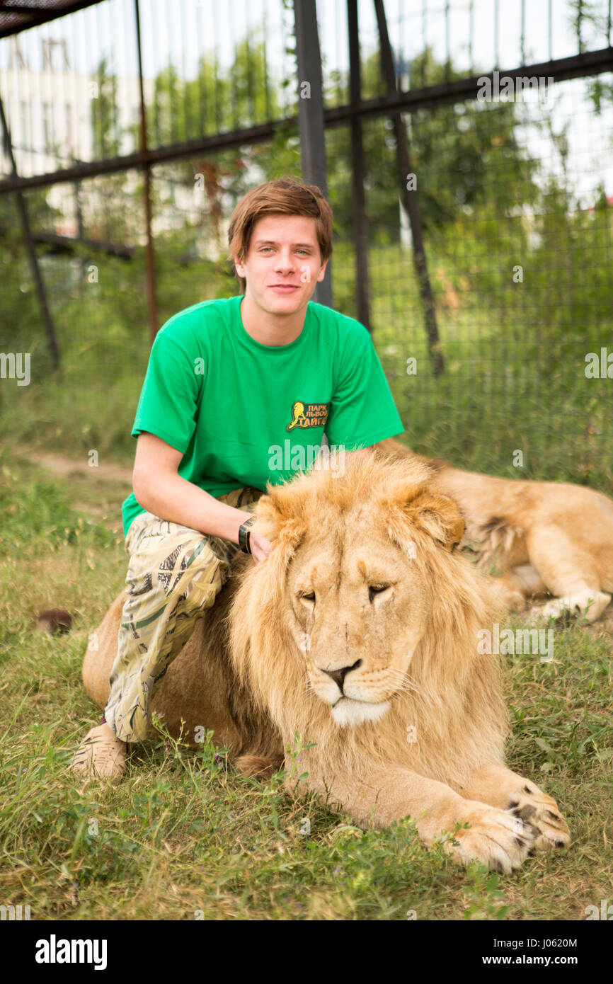 Los leones parecen estar a gusto con los seres humanos. Imágenes  impresionantes mostrando feroces leones e intrépido hombre sentado en la  parte superior de uno al otro en un campo han sido