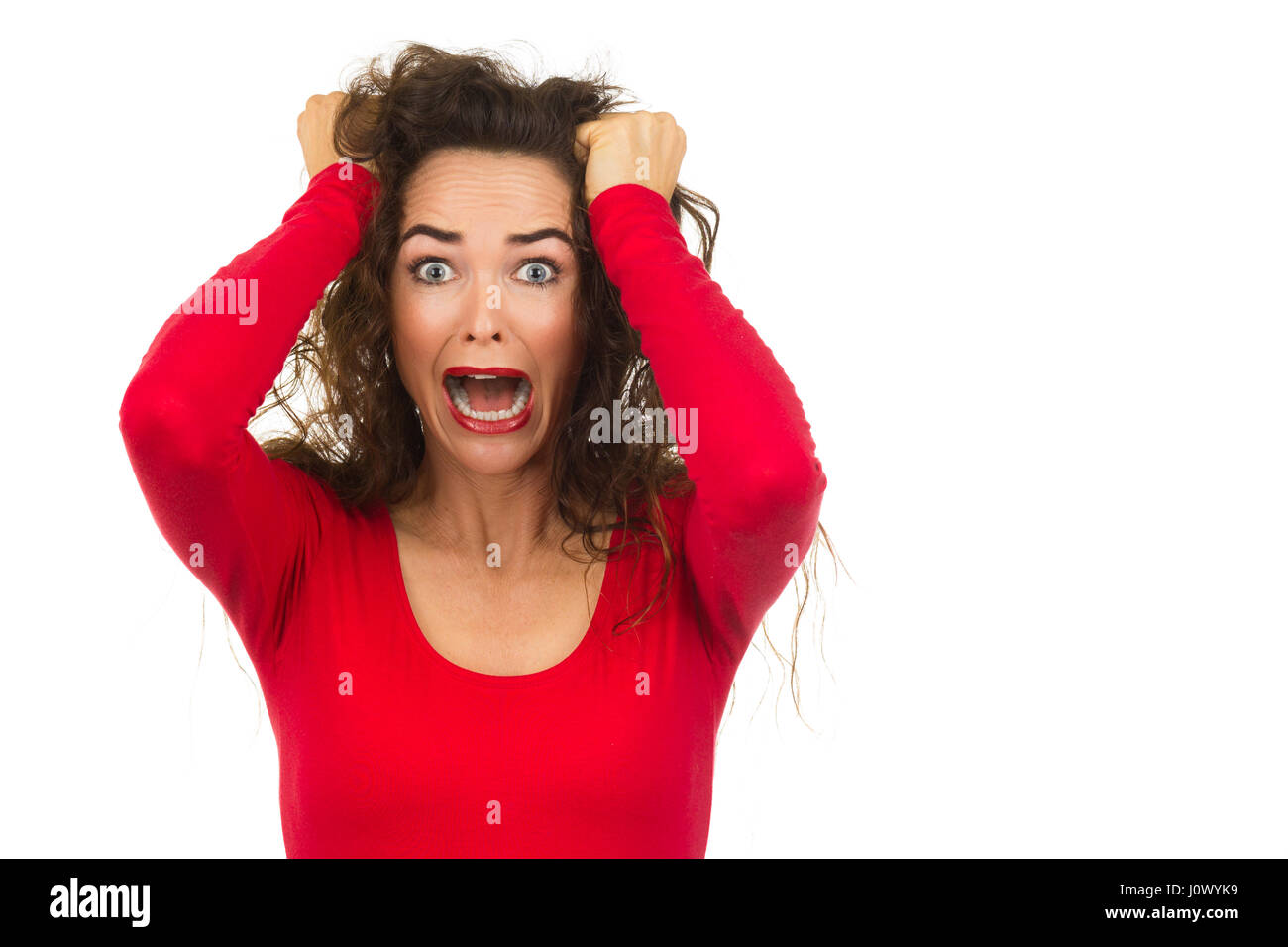 Una infeliz mujer hermosa que está teniendo un mal día de cabello aislado en blanco. Foto de stock