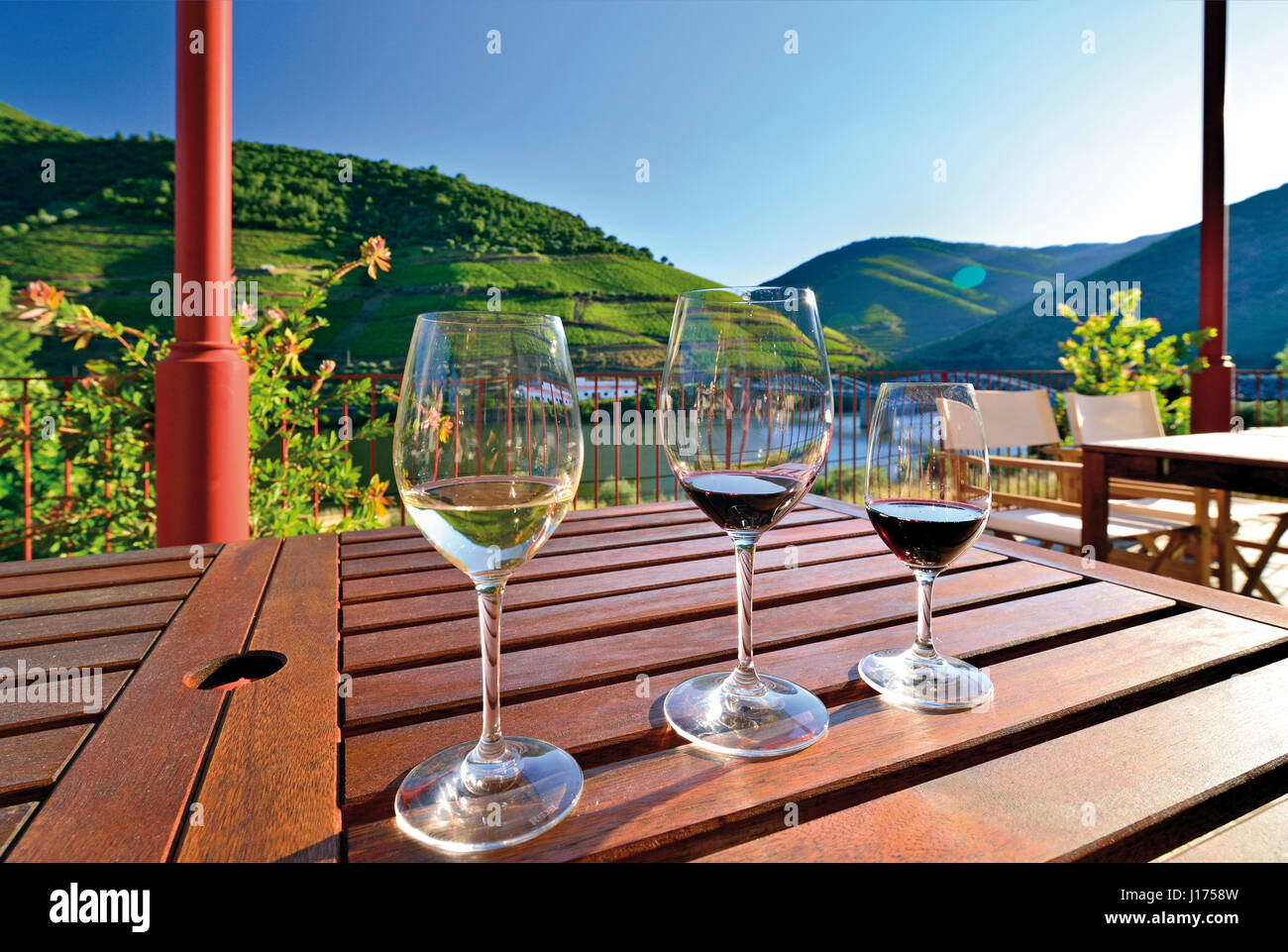 Portugal: 3 vasos de vino en una mesa con una vista estupenda del río Douro. Foto de stock