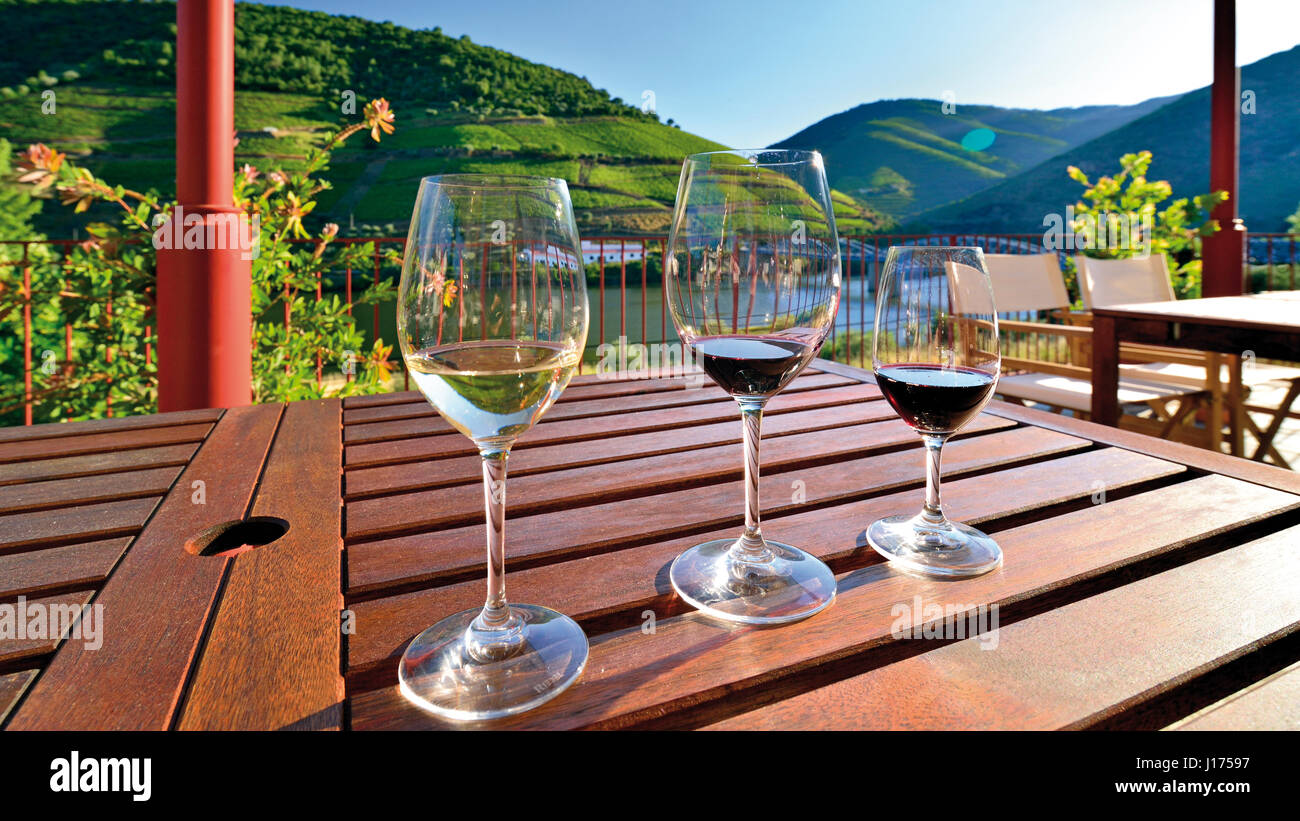Portugal: 3 vasos de vino en una mesa con una vista estupenda del río Douro. Foto de stock