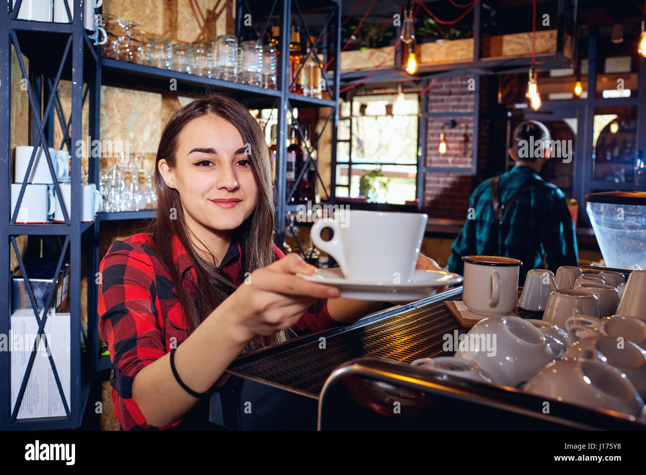 El barman chica trabaja en el bar en un restaurante Foto de stock