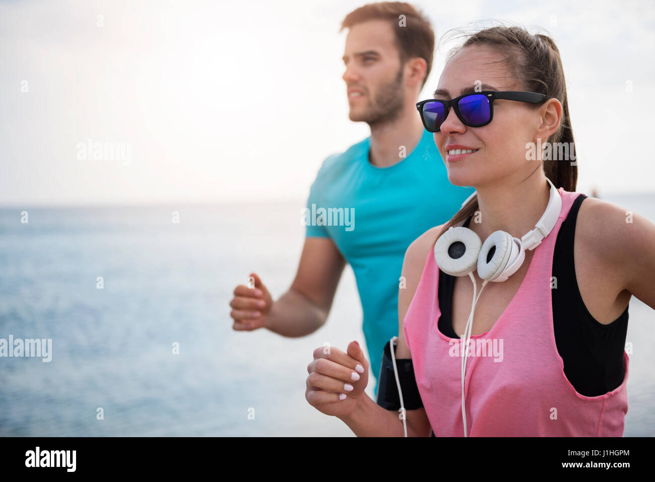 El hombre y la mujer correr juntos en día soleado Foto de stock