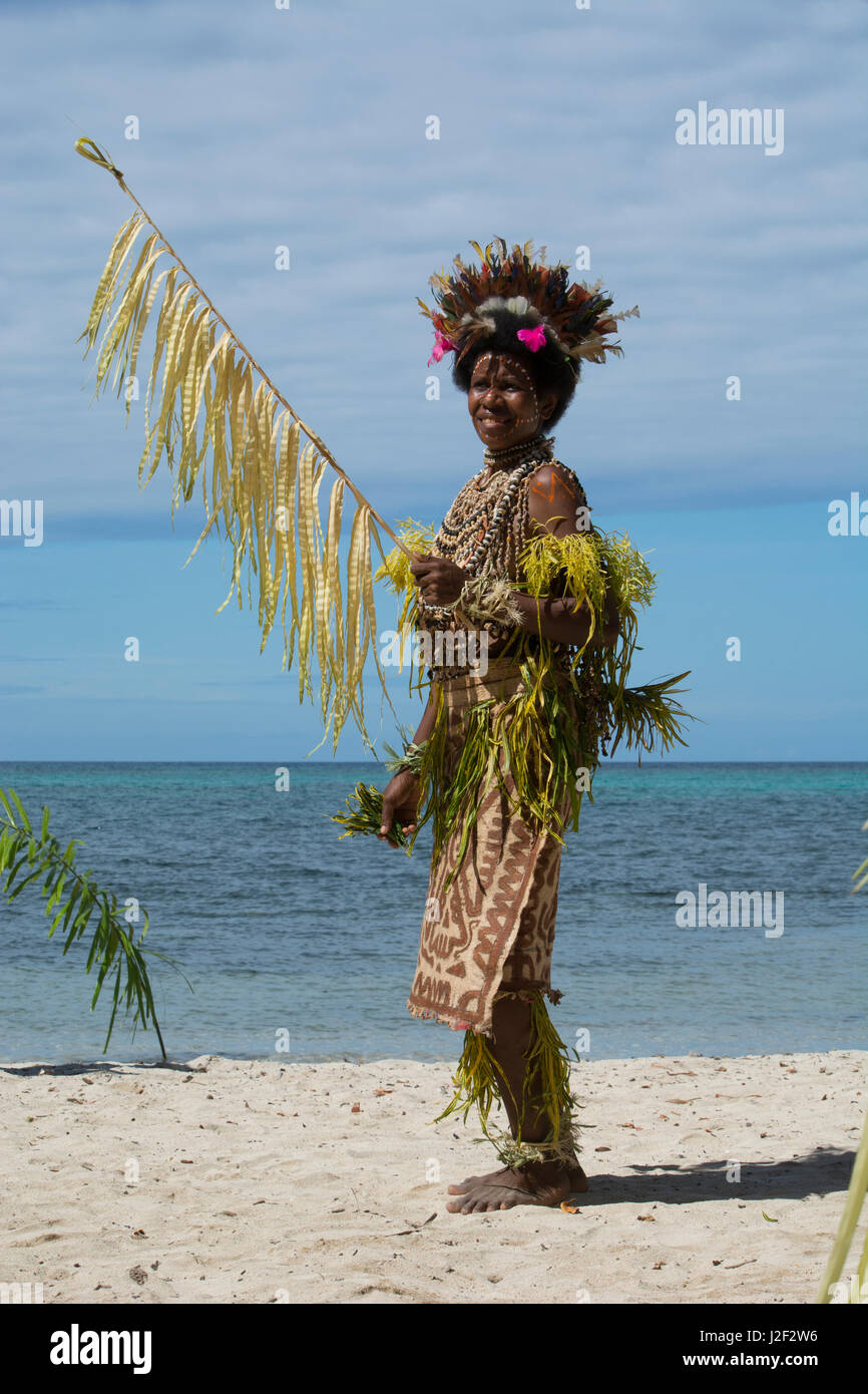 Melanesia, Papua Nueva Guinea, Tufi. Mujer en la playa vestida en el típico  sing-sing trajes nativos. Tufi es conocido por su uso de plumas de aves  tropicales ornamentados, conchas y tapa en