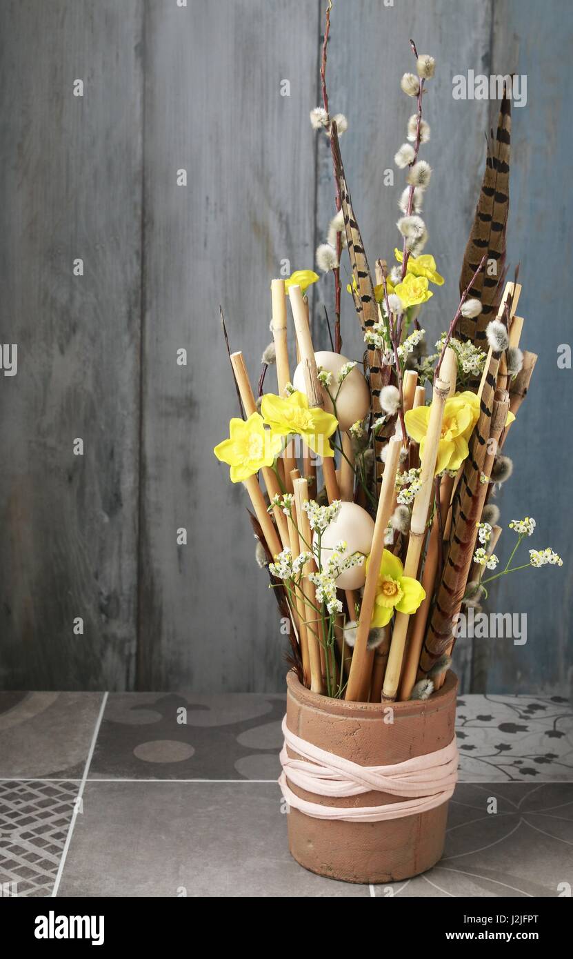 Arreglo floral artificial con narcisos y palos de bambú. Parte decoración  Fotografía de stock - Alamy