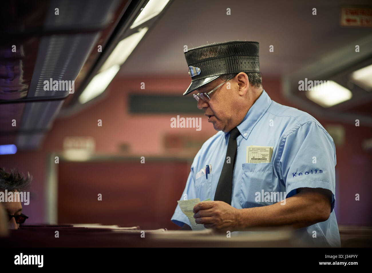 La Massachusetts Bay Transportation Authority guard inspeccionando los billetes en un tren a Boston, Massachusetts, Estados Unidos de América, EE.UU. Foto de stock