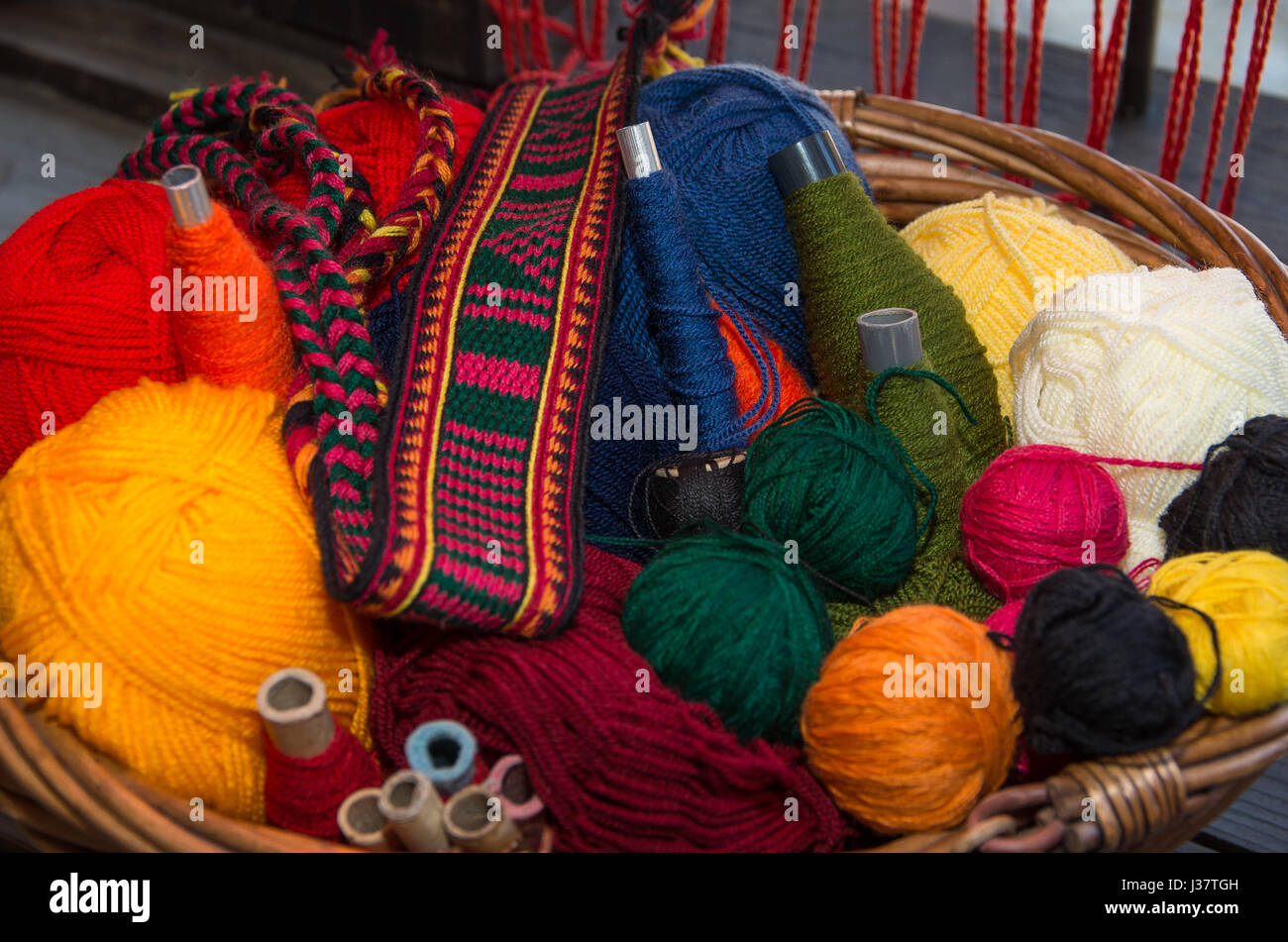 La artesanía. Cesta con hilos de lana de colores y correa tejida a mano. Imagen de fondo adecuado para Foto de stock