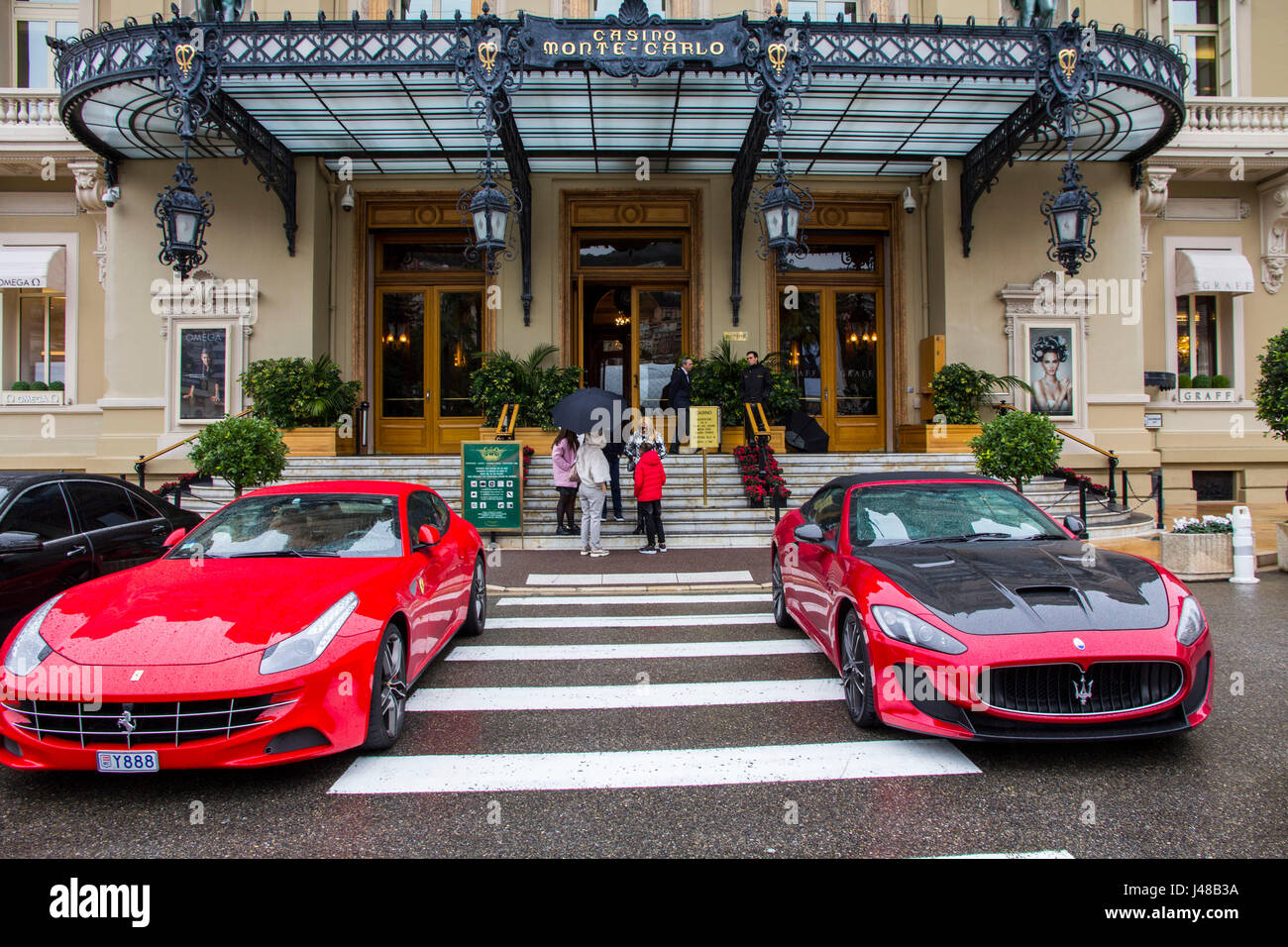 Los coches de lujo flanquean la entrada del Casino Monte Carlo, Monte Carlo, Mónaco. Foto de stock