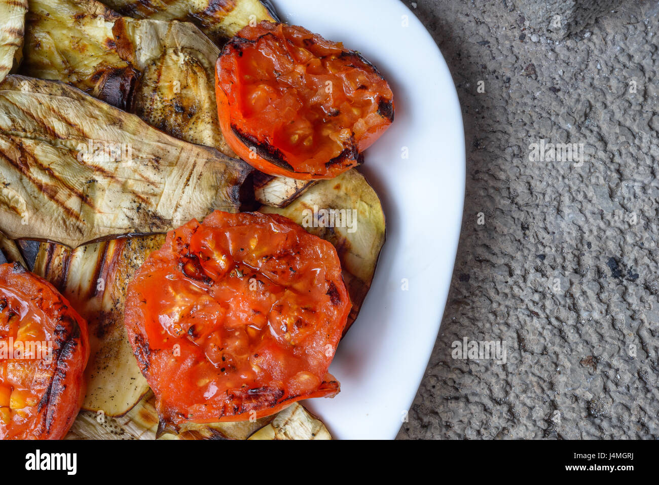 Manjar blanco con tomates asados, calabacín y berenjenas Foto de stock