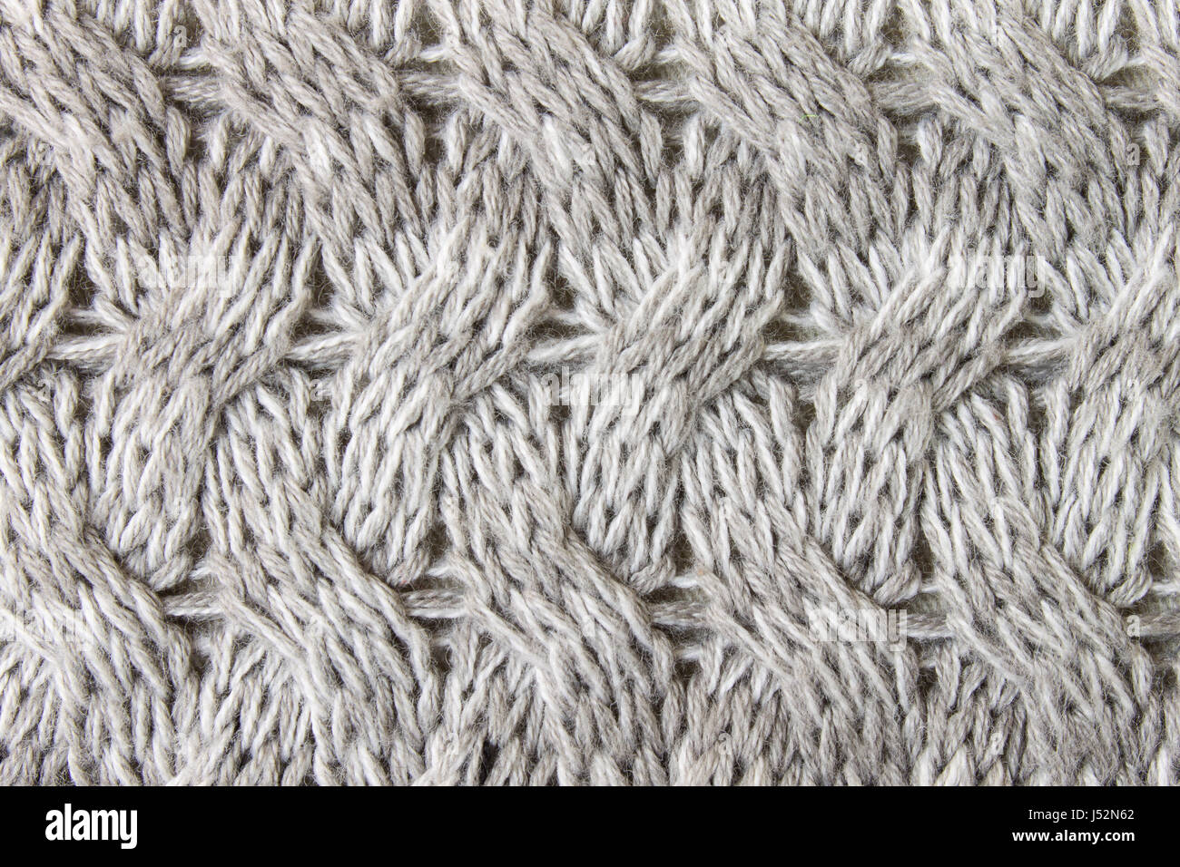 Tejido tejido gris de fondo o textura de fondo de la trama tejida. Tejido tricotado o vista cercana de fondo. Foto de stock