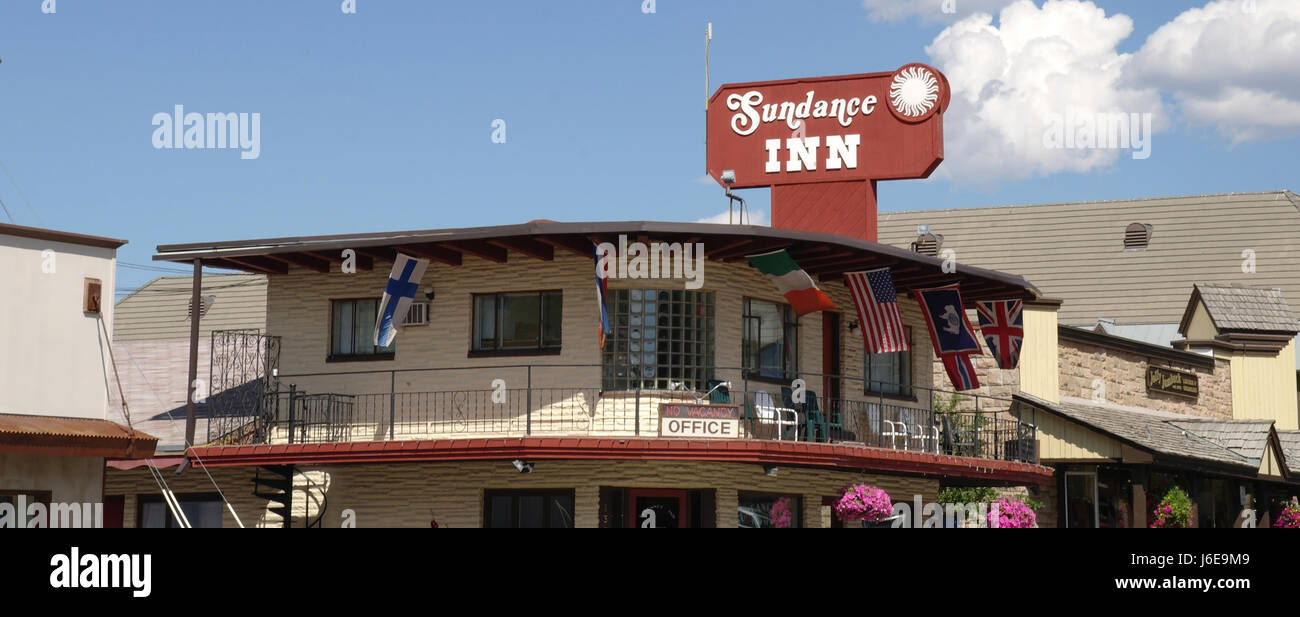 Sunny View Sundance Inn, con banderas y cestas colgantes, mirando al oriente al Jolly Jumbuck Shearlings y cuero, oeste de Broadway, en Jackson, Wyoming, EE.UU Fotografía de stock - Alamy