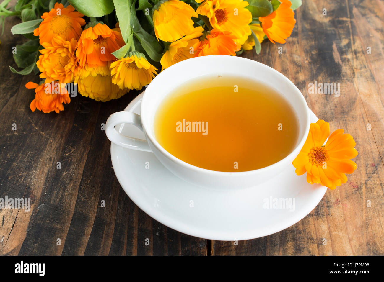 Té de caléndula , Calendula officinalis, en una taza. Foto de stock