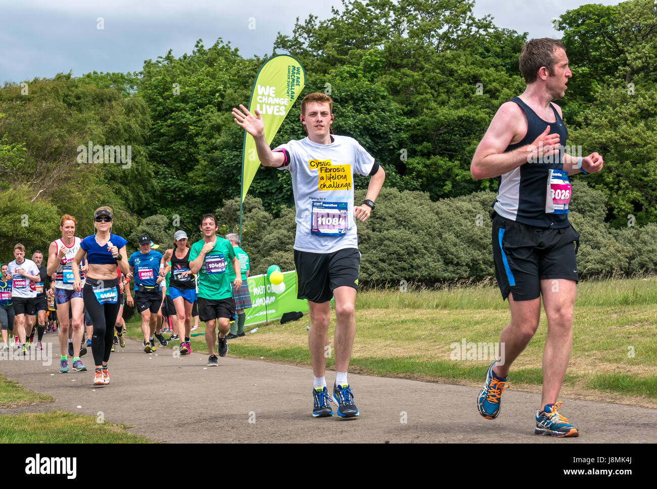 Corredores en el Festival de Maratón de Edimburgo 2017 en Gosford Estate, East Lothian, Escocia, Reino Unido con un joven que apoya la caridad de la fibrosis quística Foto de stock