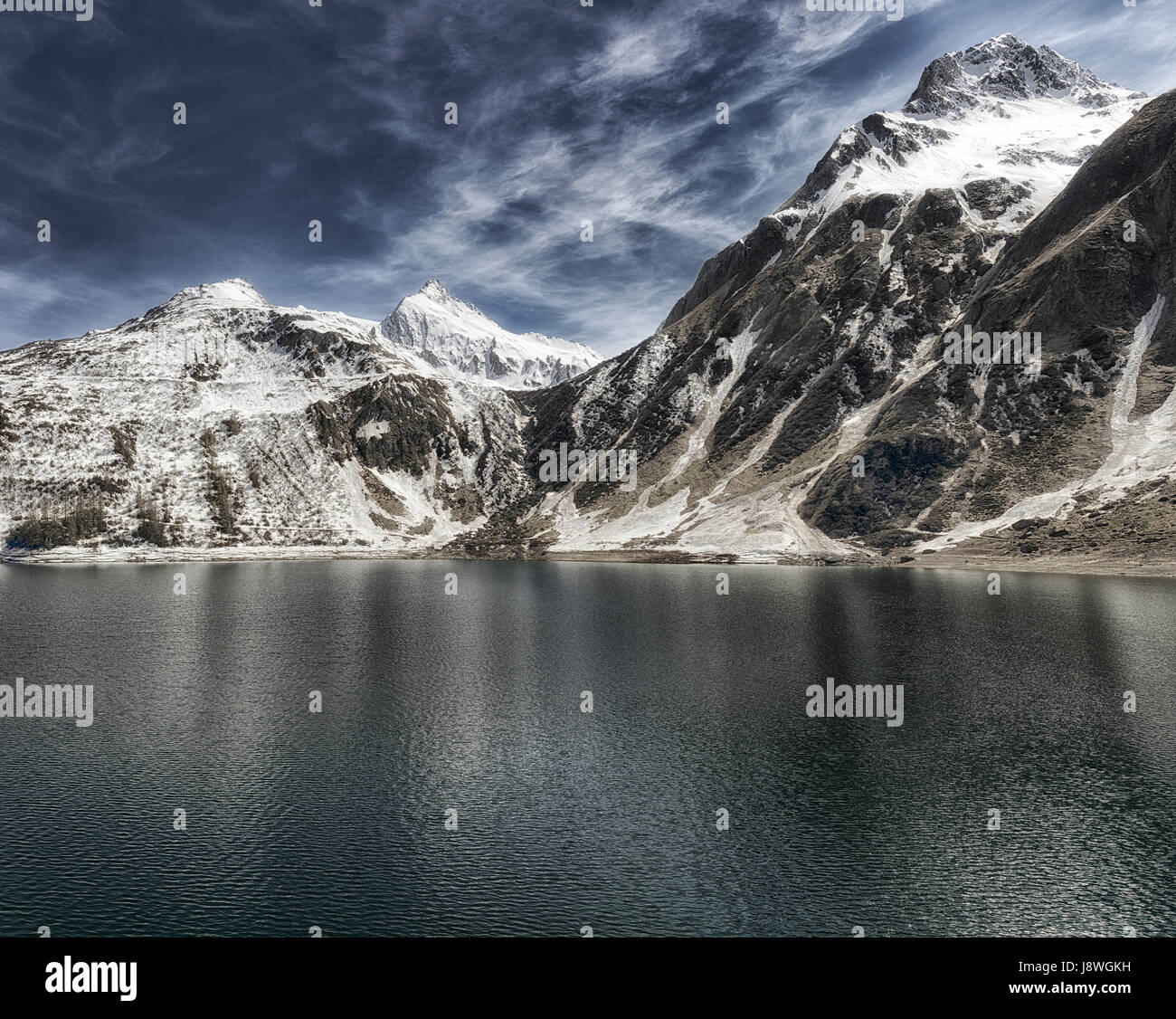 Lago alpino en el valle Formazza con el cielo azul y las nubes en un día soleado de primavera, Piamonte - Italia Foto de stock