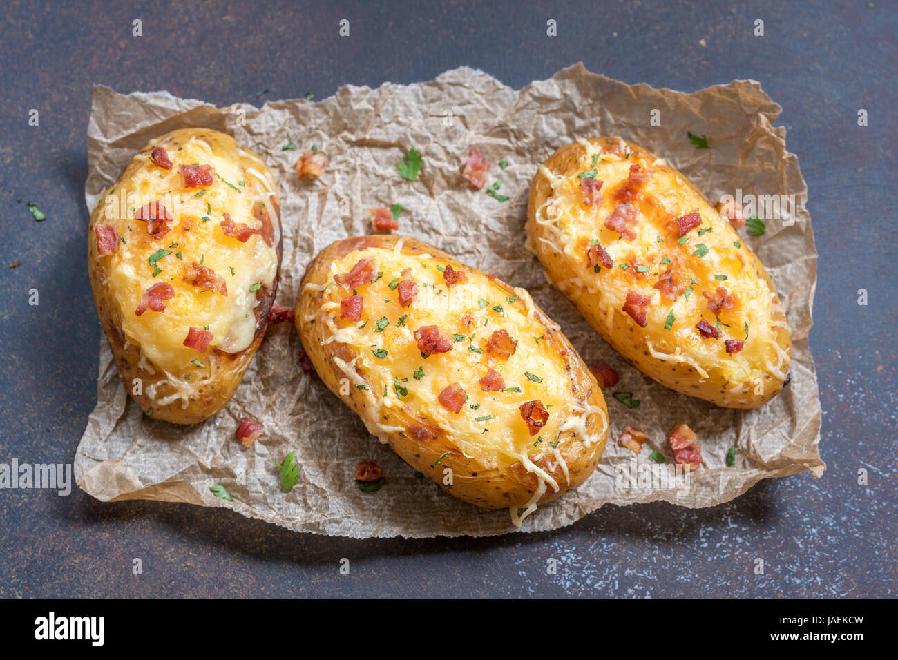 Horneado de patatas rellenas con queso y bacon. Foto de stock
