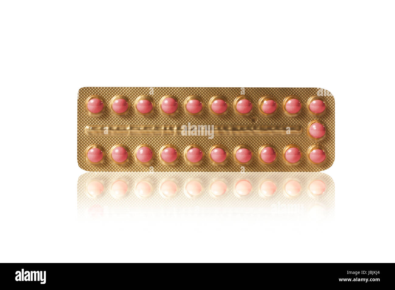 Pequeñas pastillas de color rojo en un estuche de oro Foto de stock