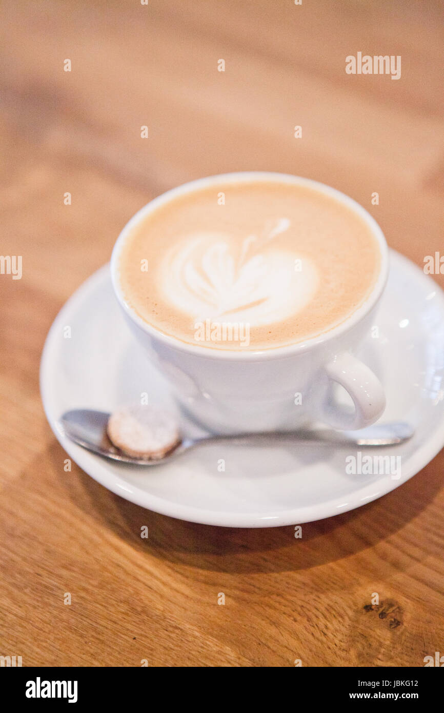 Primer plano de espresso y leche latte basado en taza de café con forma de  manzana arte diseño de tabla de madera Fotografía de stock - Alamy