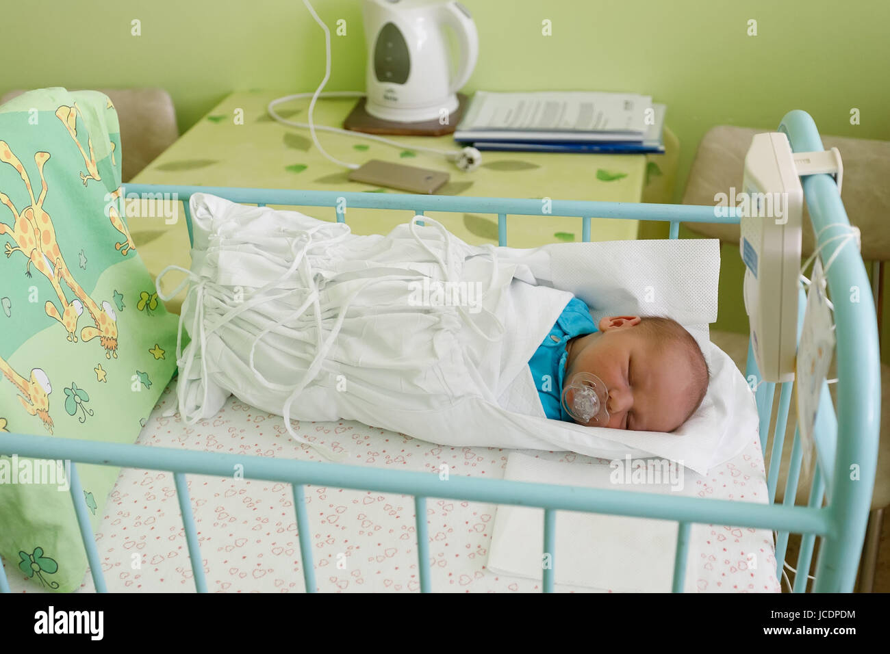 Bebé recién nacido envuelto en toalla celebrada por enfermera, cierre en  vertical Fotografía de stock - Alamy