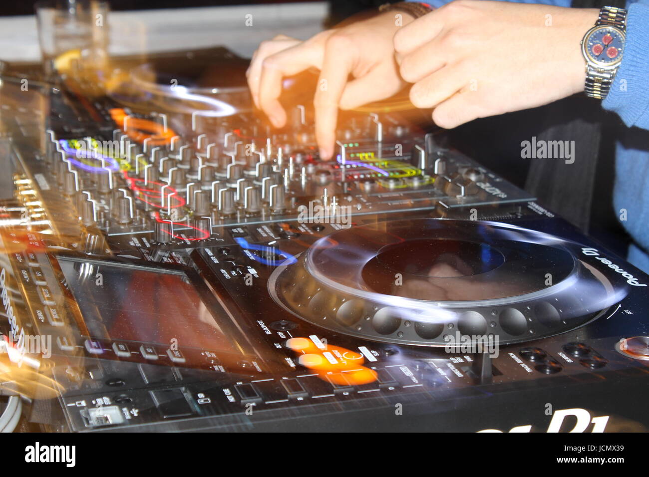 Cerca de un DJ tocando con CDJs y un mezclador Foto de stock