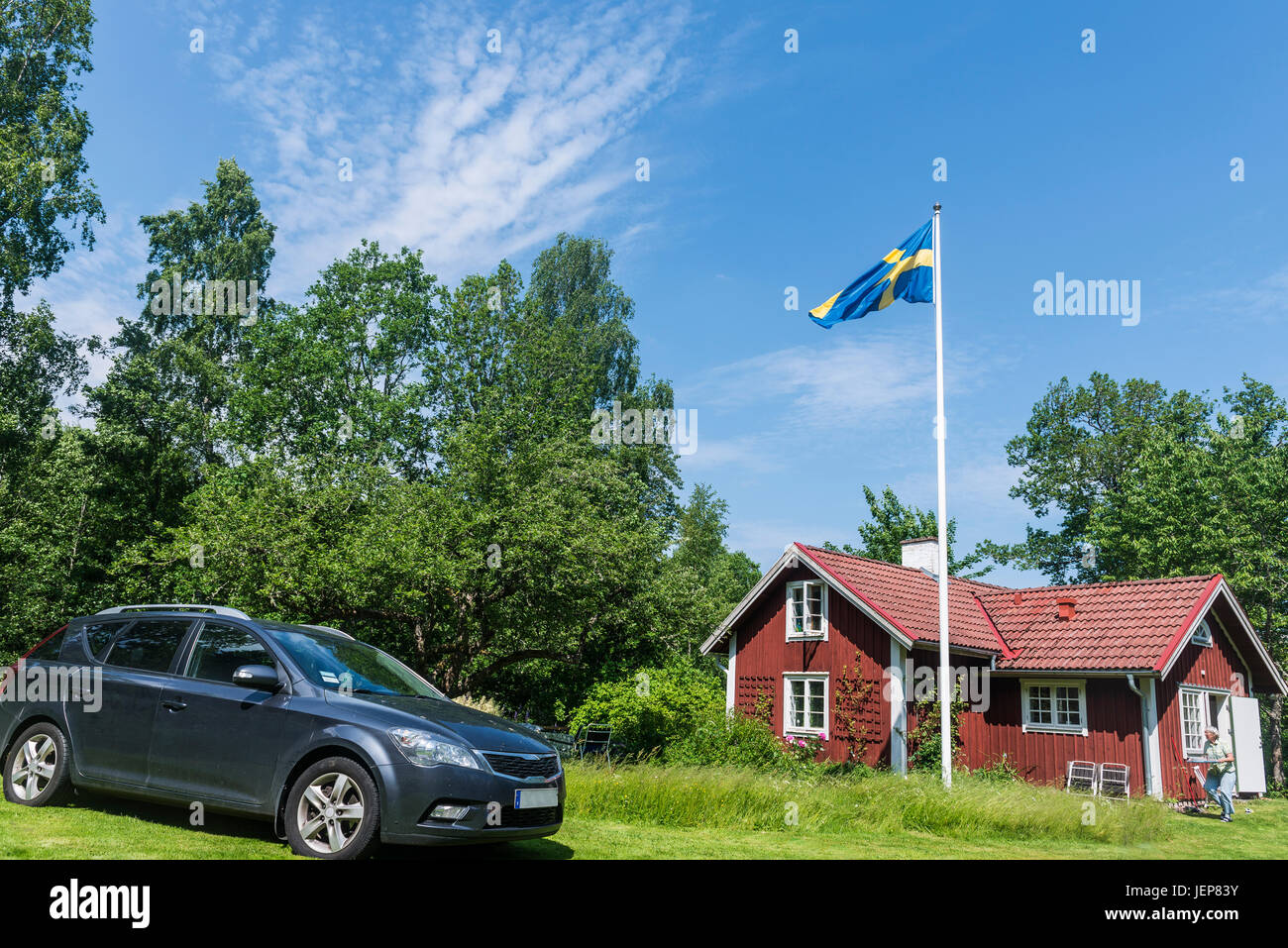 Casa de madera con la bandera sueca en la parte delantera Foto de stock
