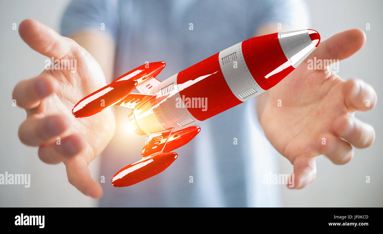El empresario sobre el fondo borroso holding red rocket en su mano 3D rendering Foto de stock