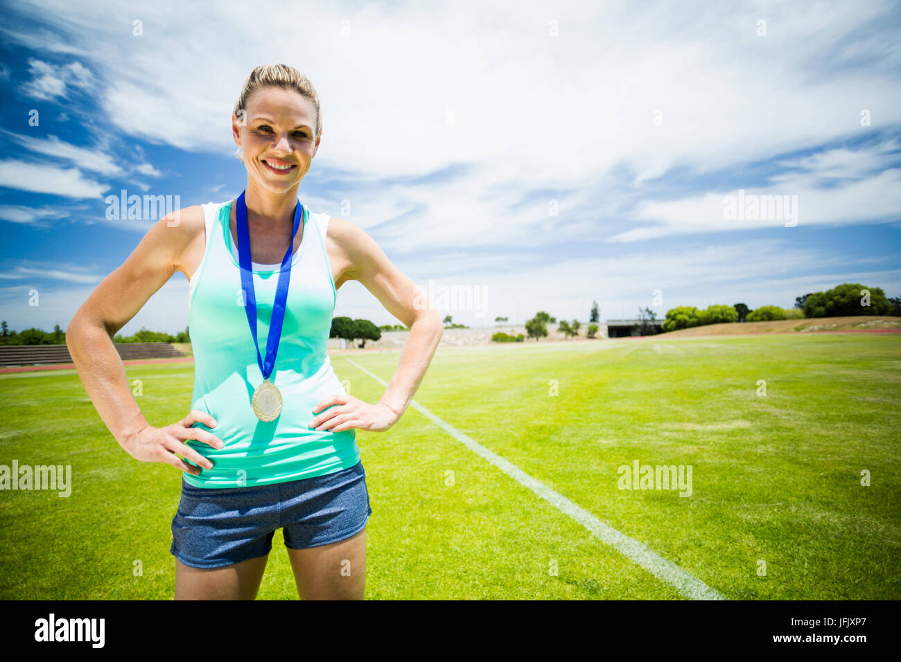 Retrato de la atleta femenina de pie con las manos en las caderas Foto de stock