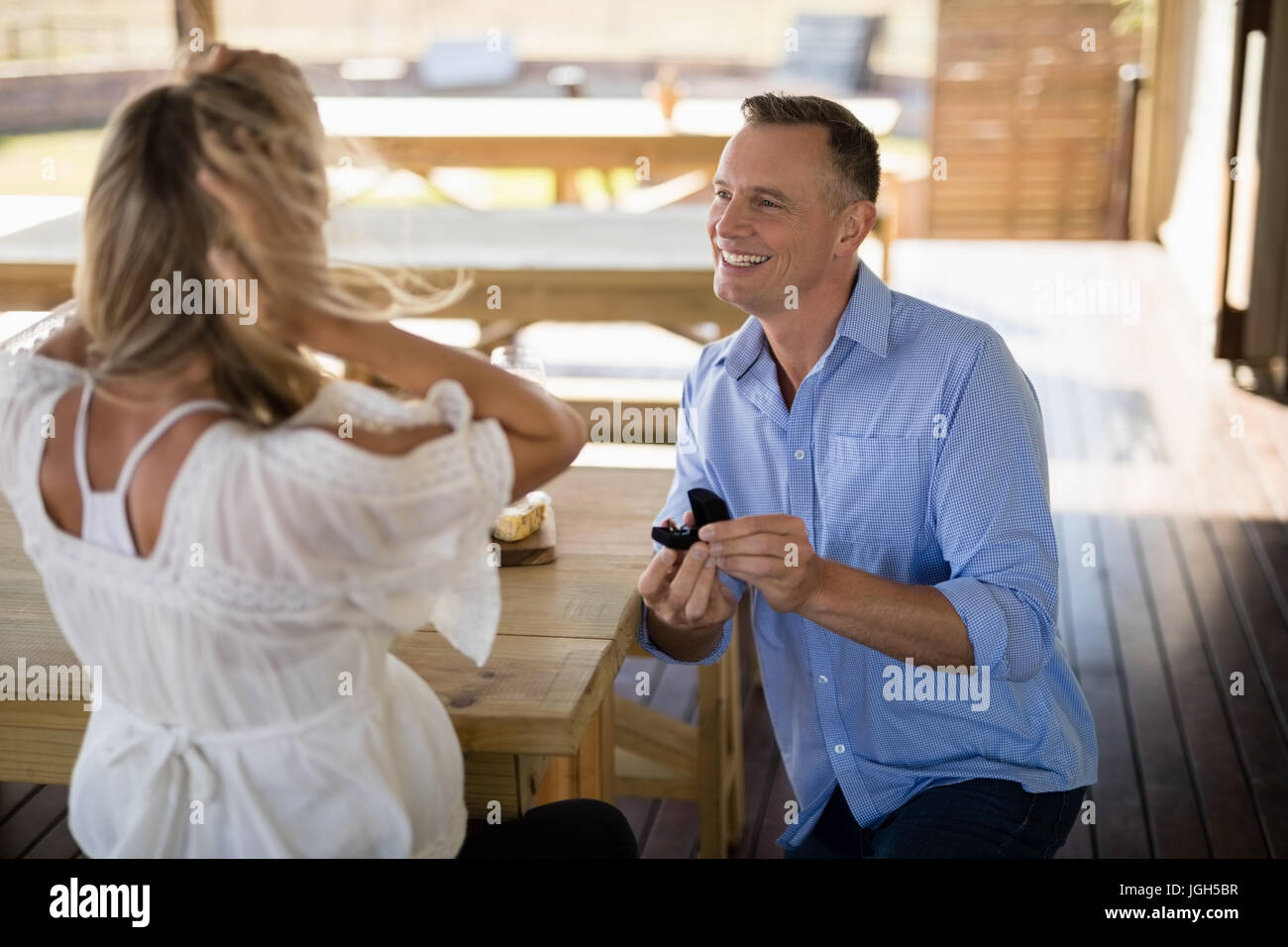 El hombre dar anillo de compromiso a la mujer sorprendida en restaurante. Foto de stock