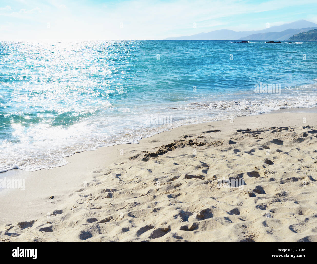 Hermosa playa con un mar azul y sun ray se refleja en el mar Foto de stock
