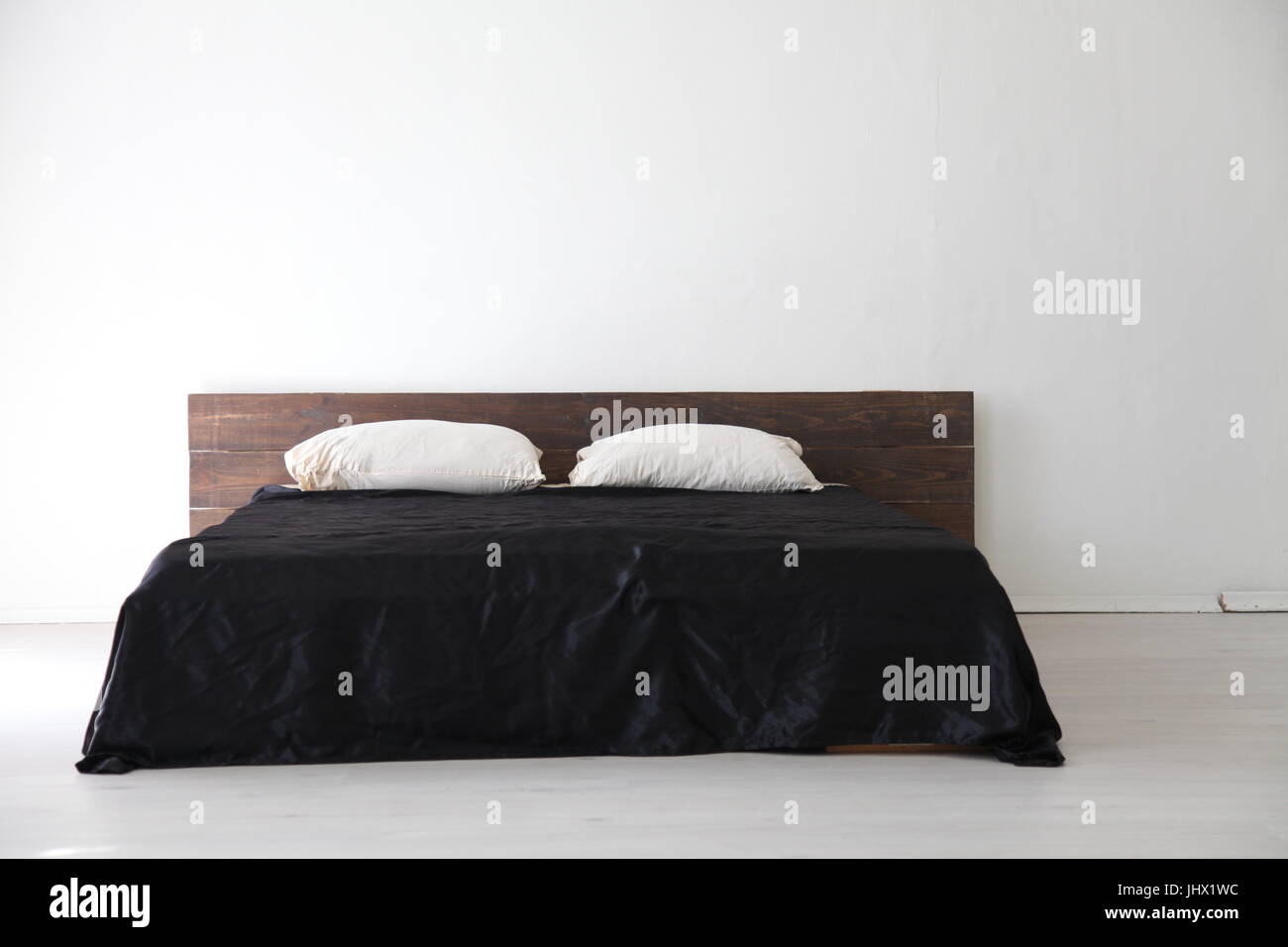 Blanco interior dormitorio y cama con sábanas negras Fotografía de stock -  Alamy